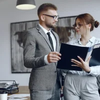 woman-with-glasses-businessman-with-documents-colleagues-work-together-ezgif.com-resize